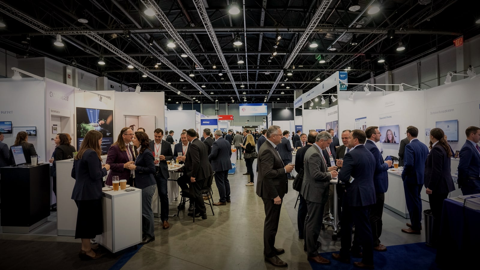 Professionals networking between exhibition booths at a trade show