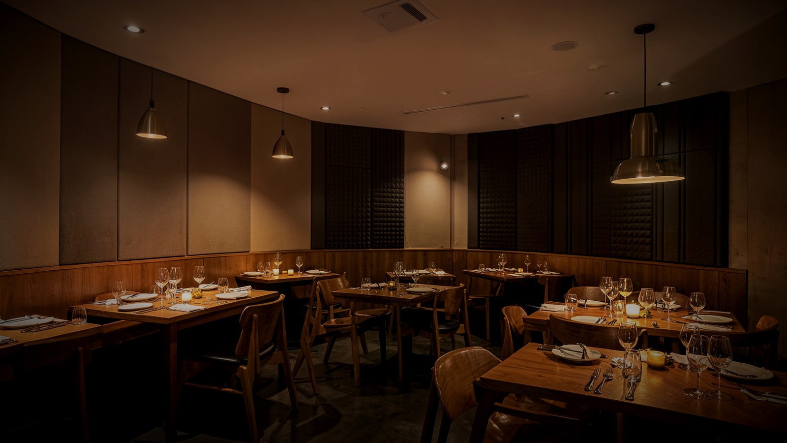 Restaurant dining room with discreet ceiling speakers and acoustic panels
